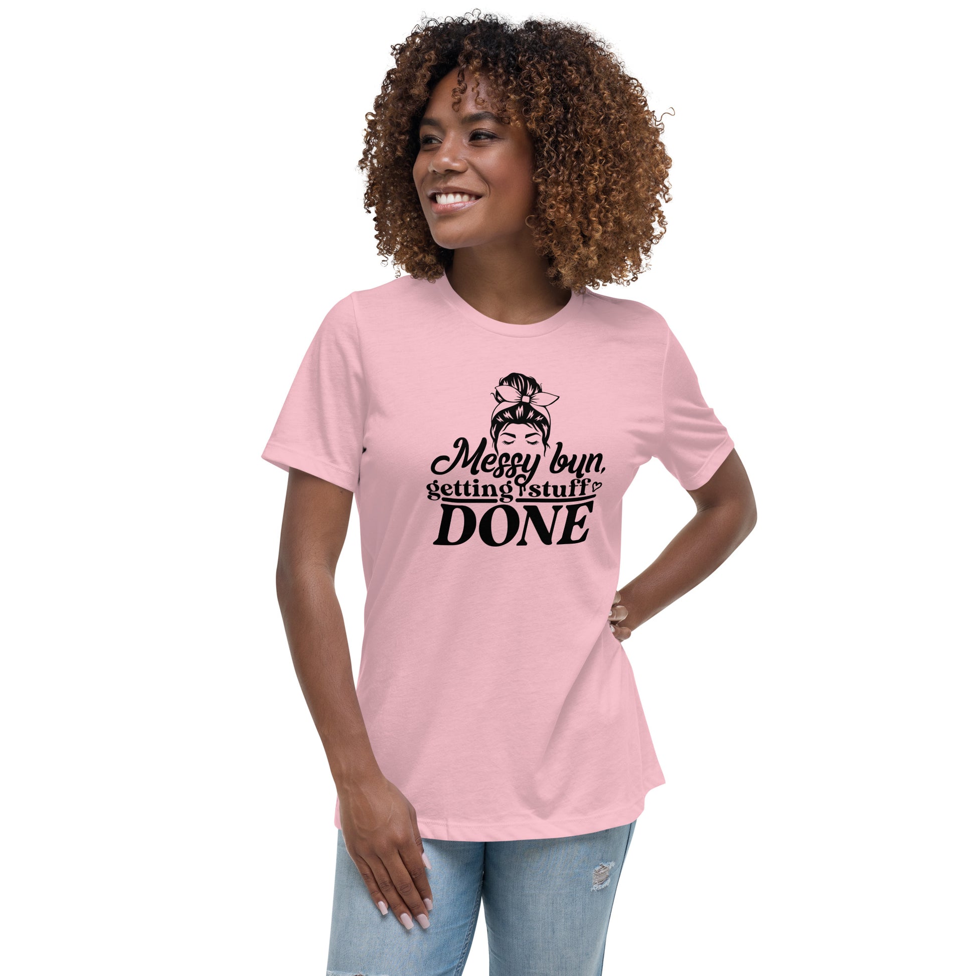 a woman wearing a pink t - shirt that says messy buns, because she